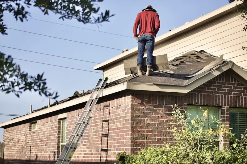 Professional roofer working on a residential roof in Osterburg